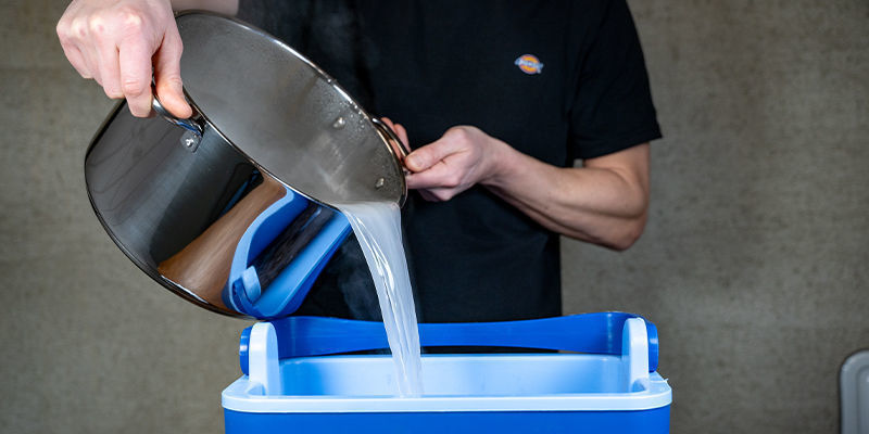 Now, once the water is boiled and the gypsum is added, you can pour it over the coco coir and vermiculite in the bucket