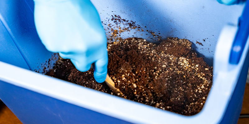 After 90 minutes, remove the lid and stir the contents to break up the coco coir