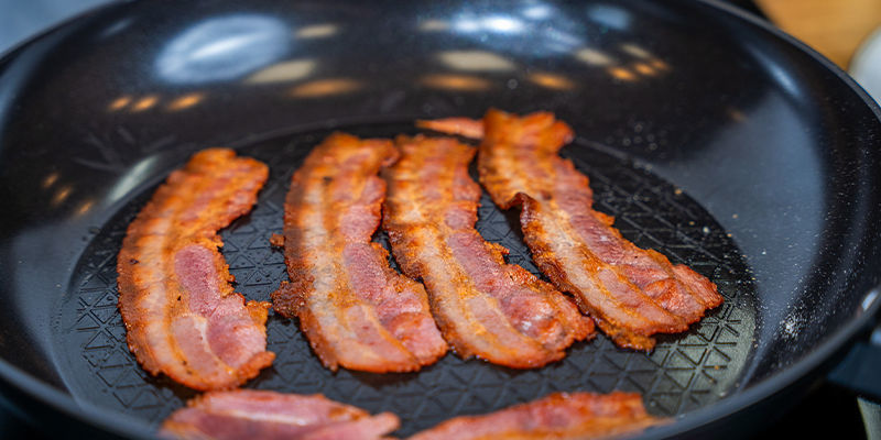 Fry The Back Bacon In The Frying Pan On A Medium Heat