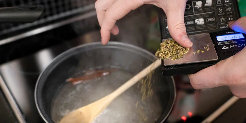 Add the decarboxylated cannabis to the saucepan and simmer on low heat for 20 minutes, stirring occasionally.