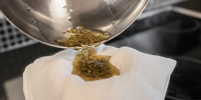 Use a cheesecloth or fine strainer to remove all plant material, as the THC will now have been extracted.