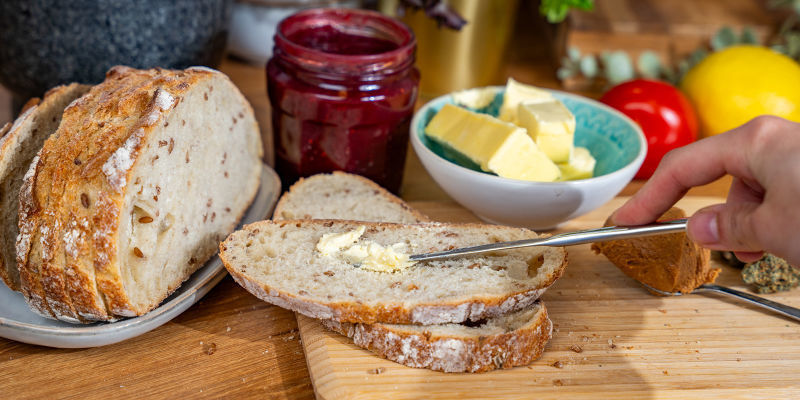 Cut Two Thick Slices Of Cannabis Bread Using The Bread Knife And Chopping Board